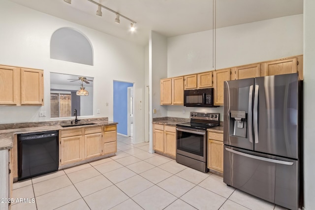 kitchen with sink, light brown cabinetry, and black appliances