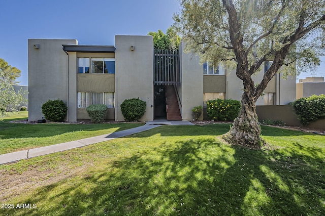4201 E Camelback Rd Unit 74, Phoenix, AZ 85018 - view of front facade with stucco siding and a front yard