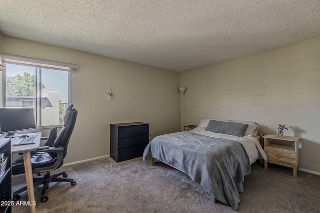 4201 E Camelback Rd Unit 74, Phoenix, AZ 85018 - bedroom with an office area, a textured ceiling, concrete block wall, and carpet floors