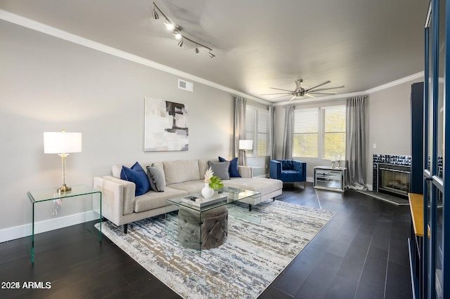 19777 N 76th St Unit 3229, Scottsdale, AZ 85255 - living area with dark wood finished floors, baseboards, ornamental molding, a ceiling fan, and a fireplace with raised hearth