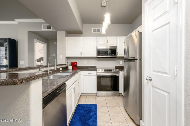 19777 N 76th St Unit 3229, Scottsdale, AZ 85255 - kitchen with appliances with stainless steel finishes, a sink, ornamental molding, white cabinets, and light tile patterned floors