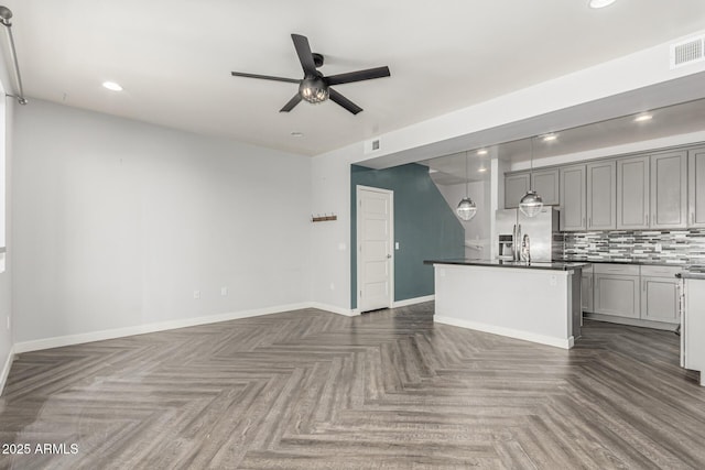 kitchen with stainless steel fridge with ice dispenser, open floor plan, gray cabinets, and a ceiling fan