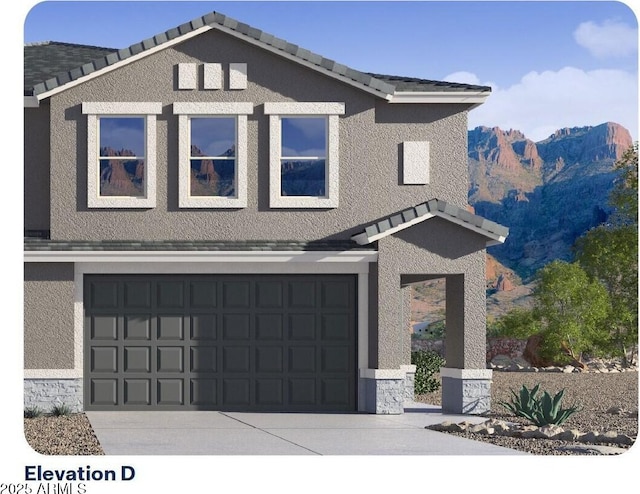 9815 S 11th St, Phoenix, AZ 85042 - view of front facade featuring a mountain view, stucco siding, an attached garage, and driveway