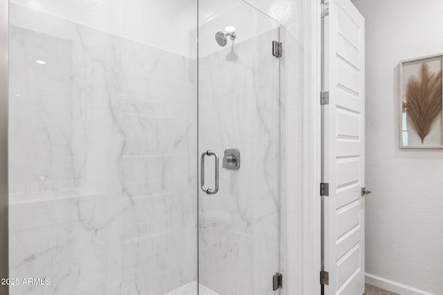 9815 S 11th St, Phoenix, AZ 85042 - bathroom featuring a marble finish shower and baseboards
