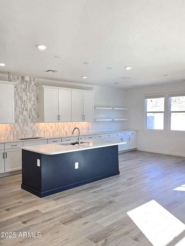 9815 S 11th St, Phoenix, AZ 85042 - kitchen with a kitchen island with sink, white cabinets, backsplash, light countertops, and recessed lighting