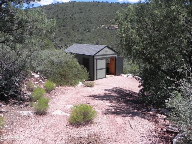 view of front of house with a storage unit