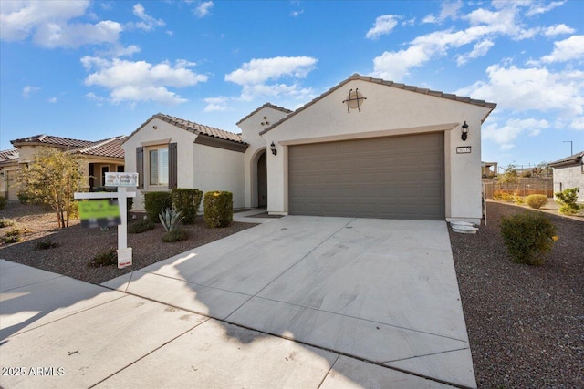 mediterranean / spanish-style home with a garage