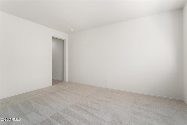 unfurnished room with light colored carpet