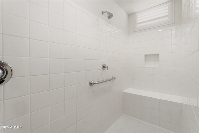 bathroom with tiled shower