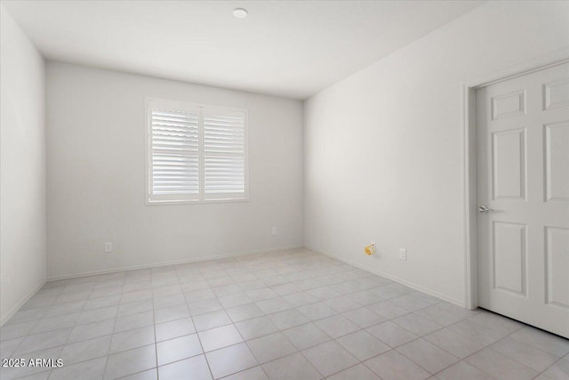 unfurnished room with light tile patterned floors