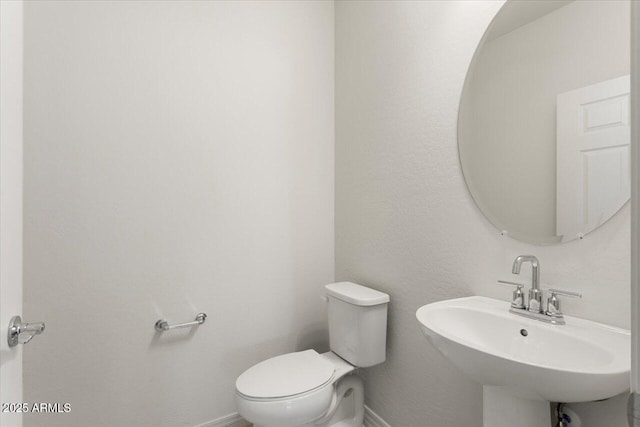 bathroom featuring sink and toilet