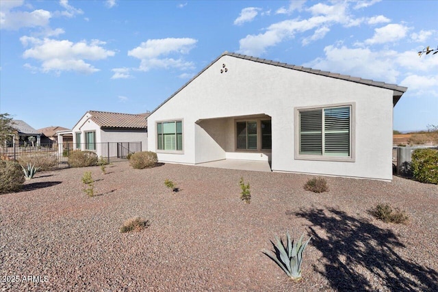 rear view of property featuring a patio