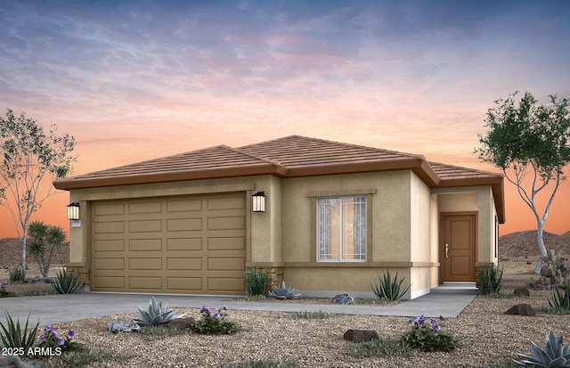 prairie-style home featuring a garage, concrete driveway, a tiled roof, and stucco siding