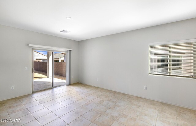 unfurnished room with visible vents and baseboards