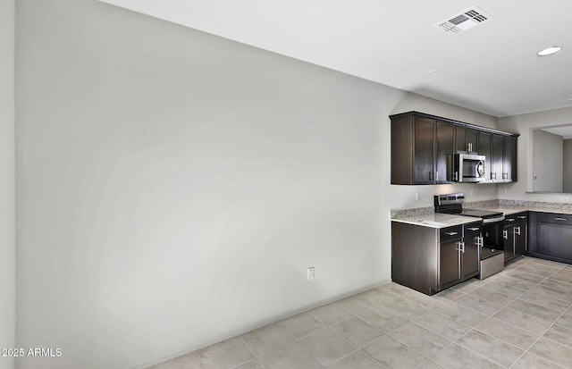 kitchen with dark brown cabinetry, visible vents, light stone counters, stainless steel appliances, and recessed lighting