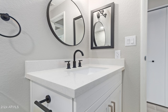 bathroom with hardwood / wood-style floors and vanity