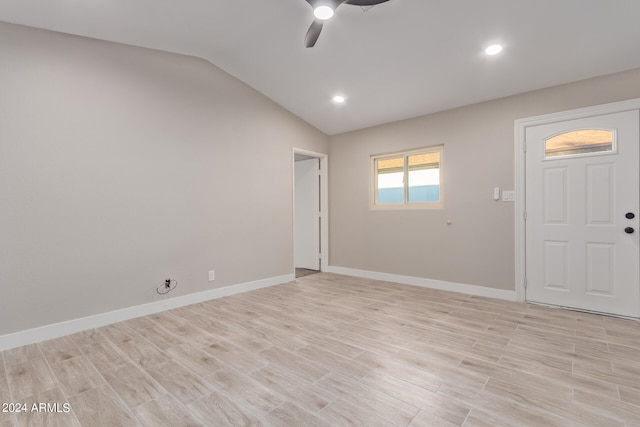 spare room featuring ceiling fan, light hardwood / wood-style flooring, and vaulted ceiling