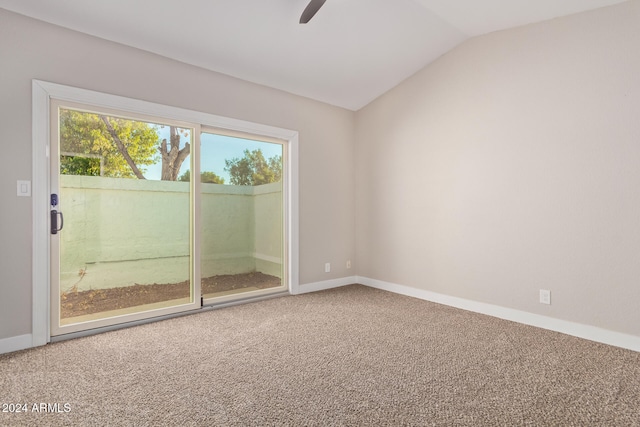 carpeted spare room with ceiling fan and lofted ceiling