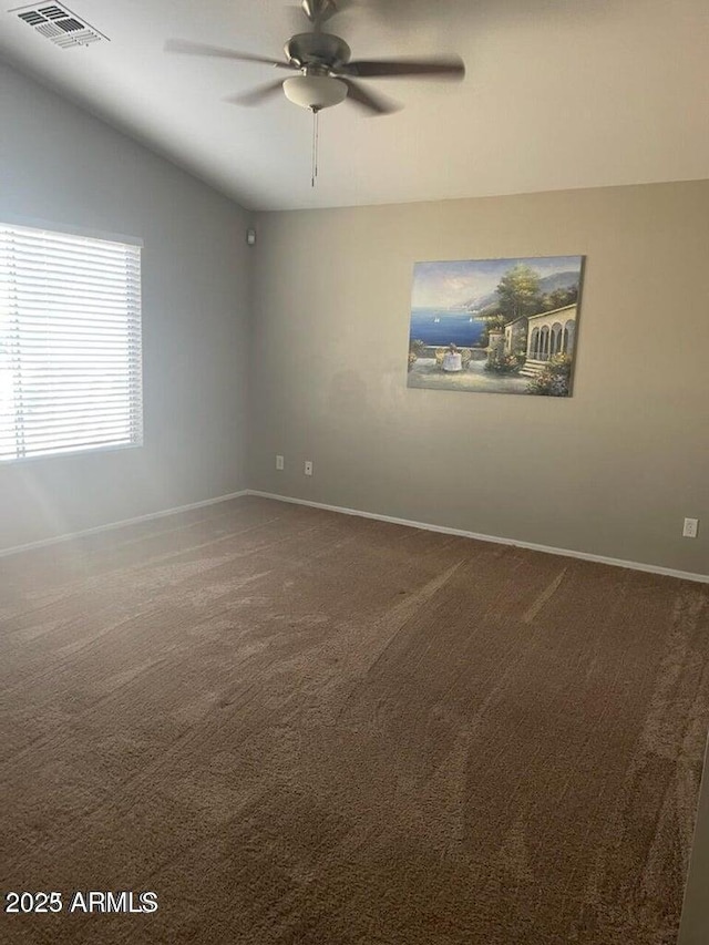 spare room featuring vaulted ceiling, ceiling fan, and carpet flooring