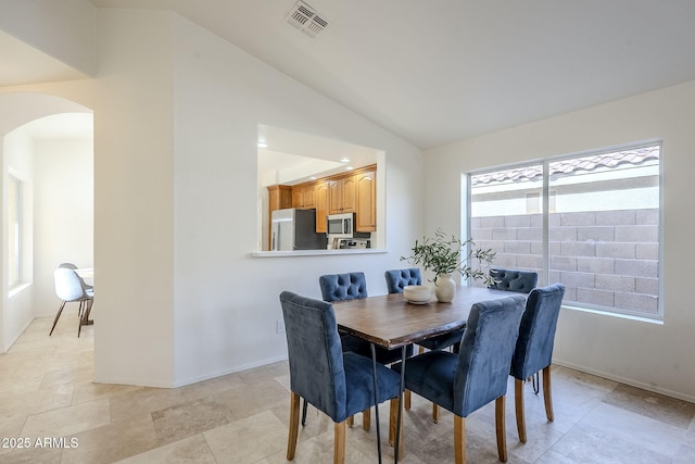 dining room featuring lofted ceiling