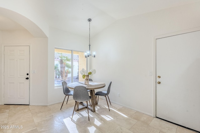 dining room with lofted ceiling and a notable chandelier