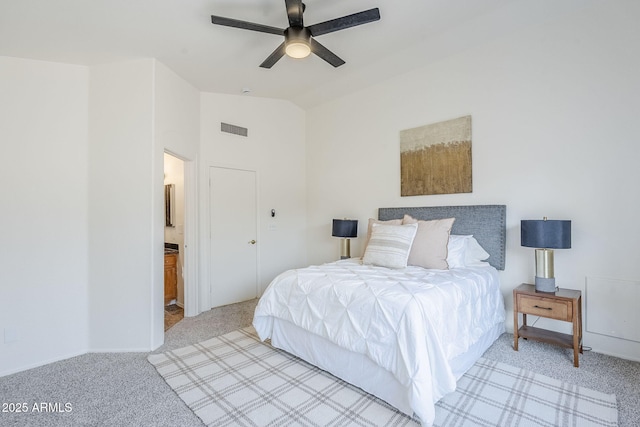 carpeted bedroom with vaulted ceiling, connected bathroom, and ceiling fan