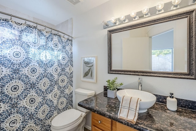 bathroom with vanity, toilet, and walk in shower