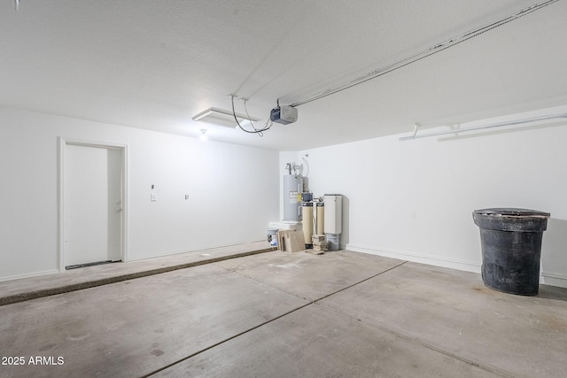 garage with a garage door opener and electric water heater