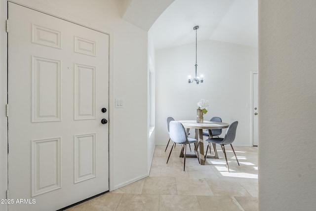 dining room featuring vaulted ceiling and a notable chandelier