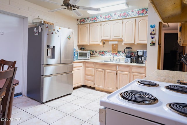 kitchen with light tile patterned flooring, stainless steel fridge with ice dispenser, sink, ceiling fan, and white range with electric cooktop