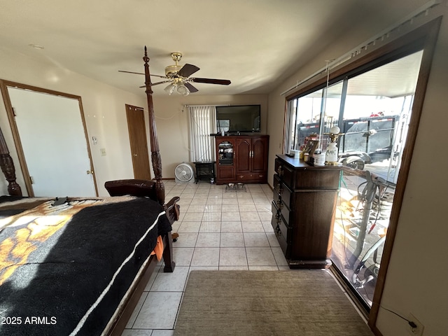 interior space featuring light tile patterned floors and ceiling fan