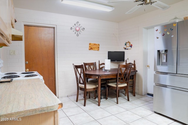 tiled dining area featuring ceiling fan