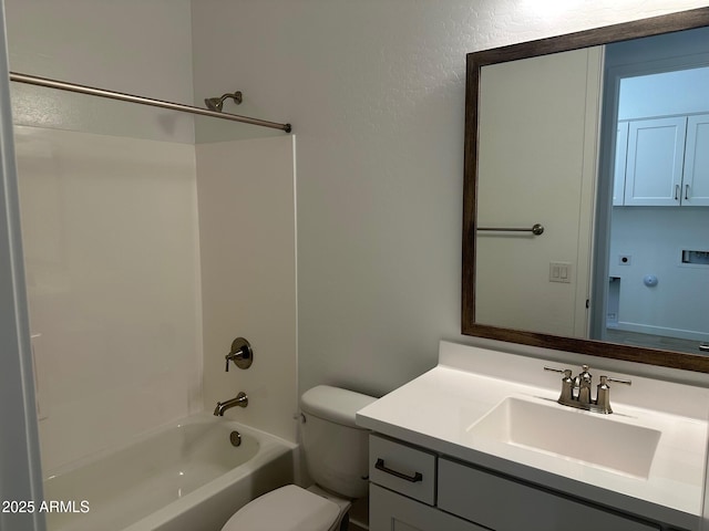 bathroom with tub / shower combination, toilet, and vanity