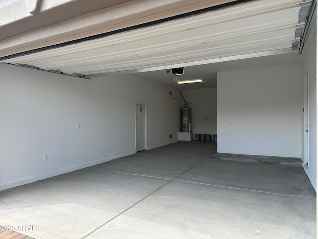 garage with water heater, a garage door opener, and baseboards