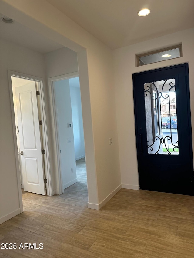 entrance foyer featuring light wood-style floors, recessed lighting, and baseboards