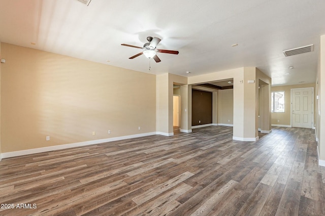 unfurnished living room featuring ceiling fan, wood finished floors, visible vents, and baseboards