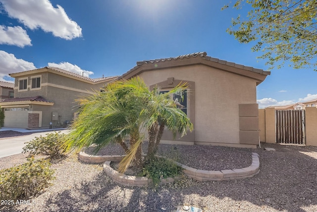 view of home's exterior featuring a gate and stucco siding