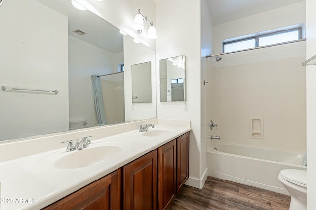 full bathroom with toilet, shower / bathing tub combination, a sink, and wood finished floors