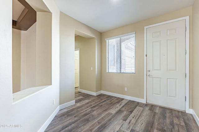 entrance foyer featuring baseboards and wood finished floors