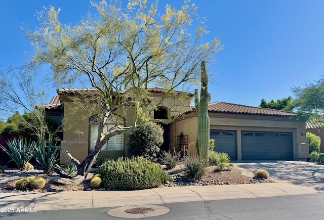 5149 E Silver Sage Ln, Cave Creek, AZ 85331 - mediterranean / spanish house with stucco siding, a garage, a tile roof, and concrete driveway