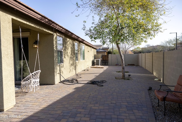 view of patio / terrace featuring cooling unit and a fenced backyard