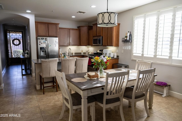 dining room featuring light tile patterned flooring, a wealth of natural light, and recessed lighting