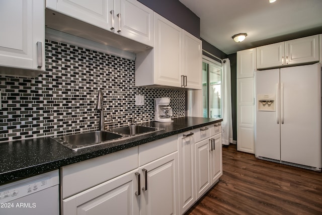 kitchen featuring white appliances, sink, dark hardwood / wood-style floors, tasteful backsplash, and white cabinetry