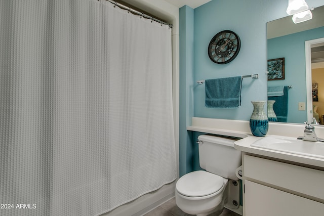 bathroom with tile patterned flooring, vanity, and toilet