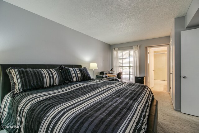 carpeted bedroom with a textured ceiling