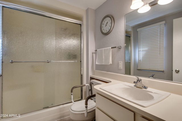 bathroom with vanity, toilet, and walk in shower