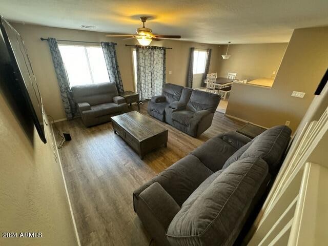 living room with ceiling fan and hardwood / wood-style floors