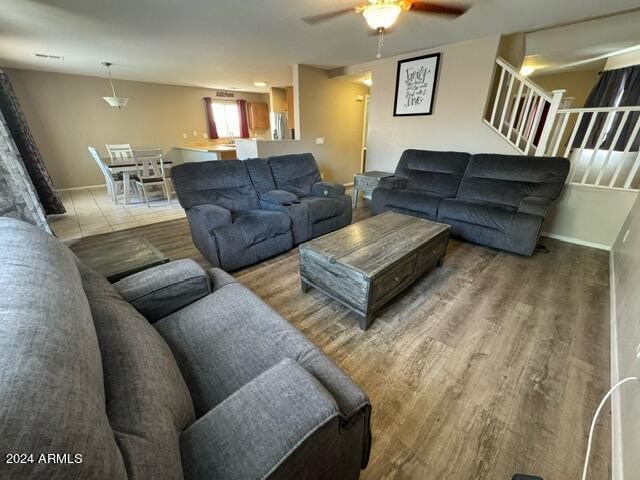 living room with hardwood / wood-style floors and ceiling fan