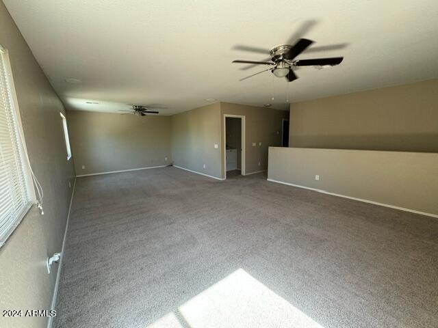 spare room with carpet floors and ceiling fan