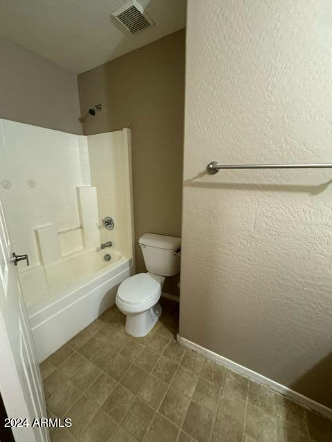 bathroom with shower / washtub combination and toilet